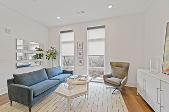 a living room with white walls and hardwood floors