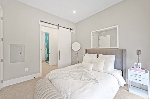 Bedroom with a large bed and white walls at Four23/Hoge, Cincinnati, OH
