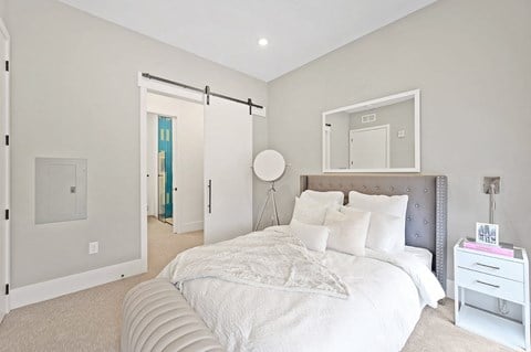 a bedroom with a large bed and white walls at Four23/Hoge, Cincinnati, OH