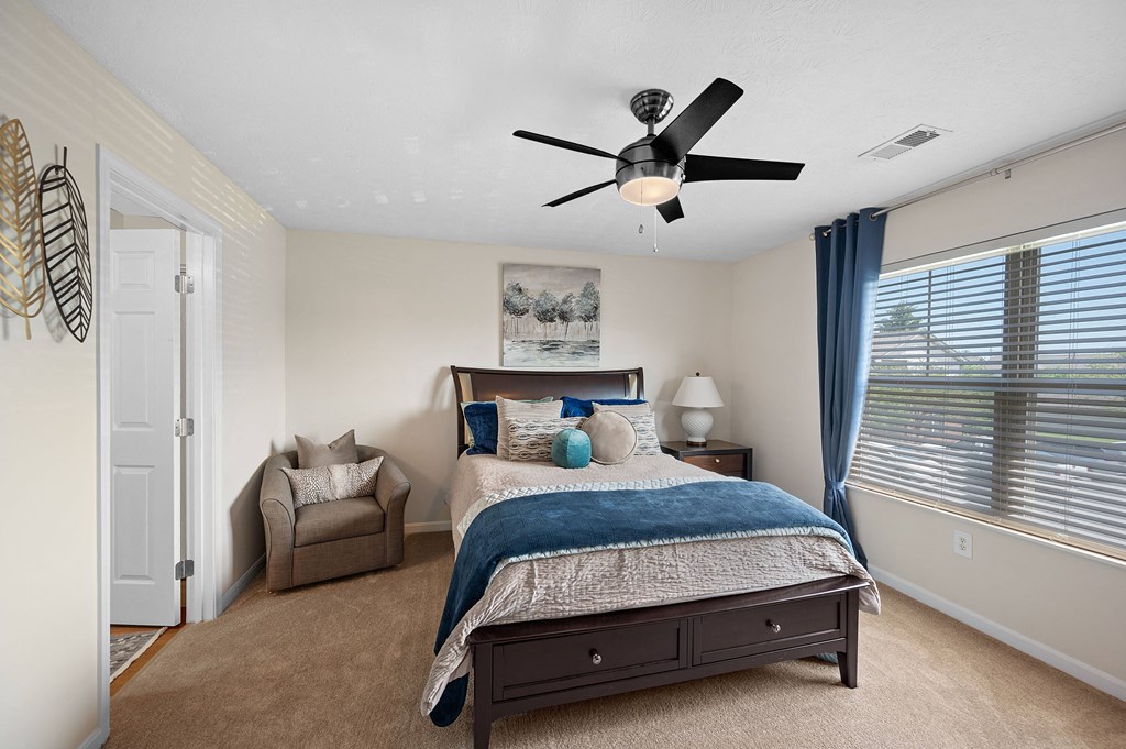 Bedroom with a bed and a ceiling fan at Four Bridges, Liberty Township
