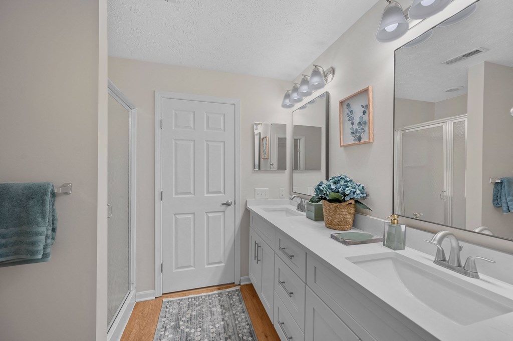 White bathroom with a sink and a mirror at Four Bridges, Liberty Township, Ohio