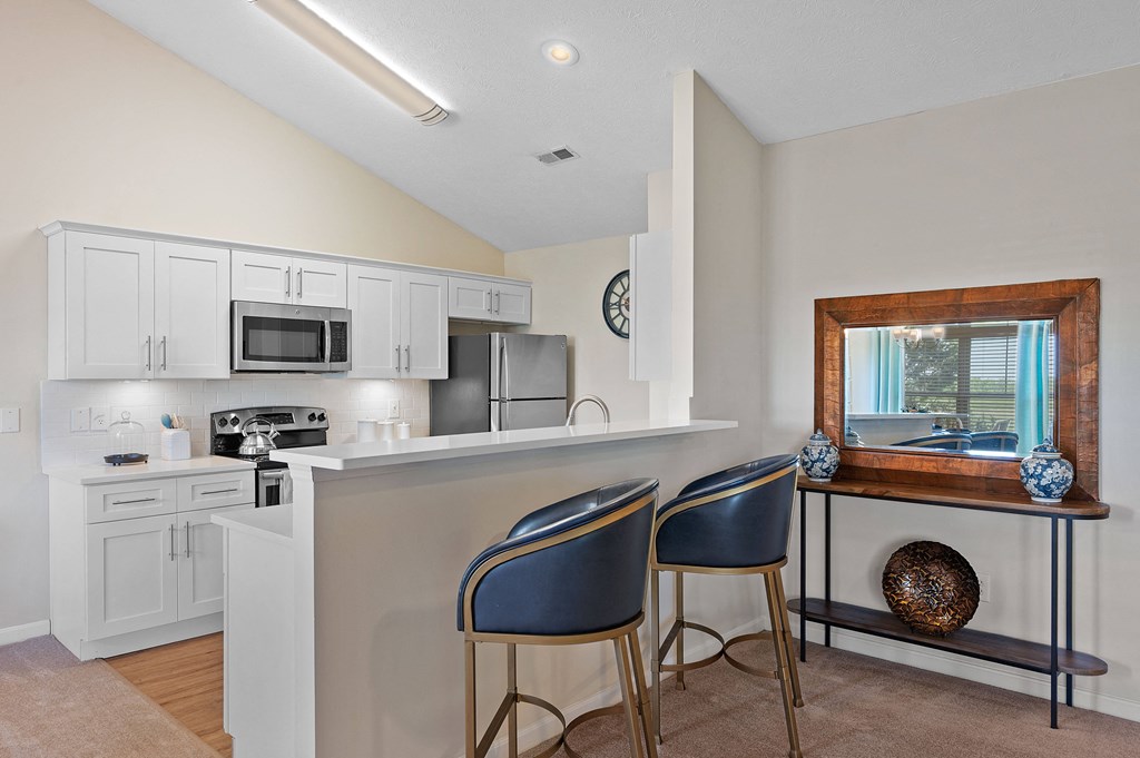 Kitchen with a bar with two chairs and a sink at Four Bridges, Liberty Township, OH, 45044-8380