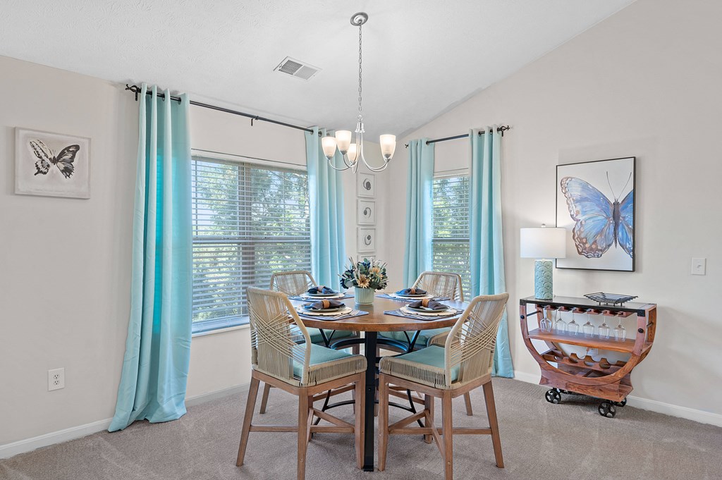 Dining room with a table and chairs and a chandelier at Four Bridges, Liberty Township, OH, 45044-8380
