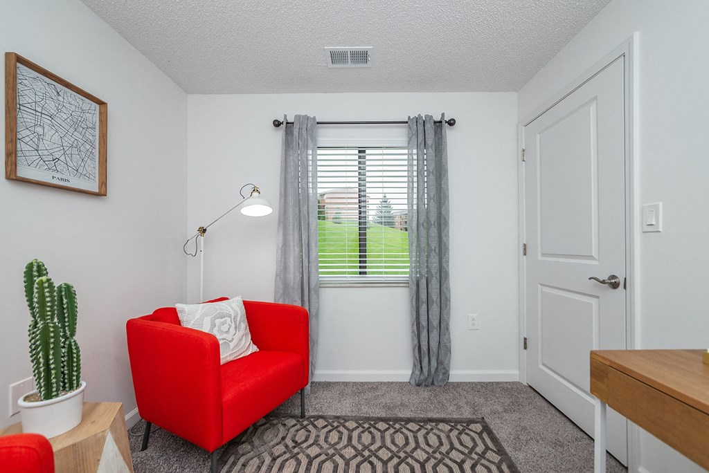 a living room with a red chair and a window at Weaver Farm, Florence, 41042