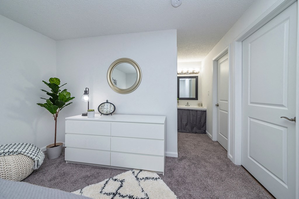 a white bedroom with a white dresser and a mirror at Weaver Farm, Kentucky