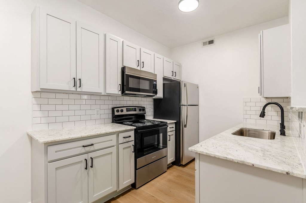 a kitchen with white cabinets and stainless steel appliances at Prescott Place, Columbus, Ohio