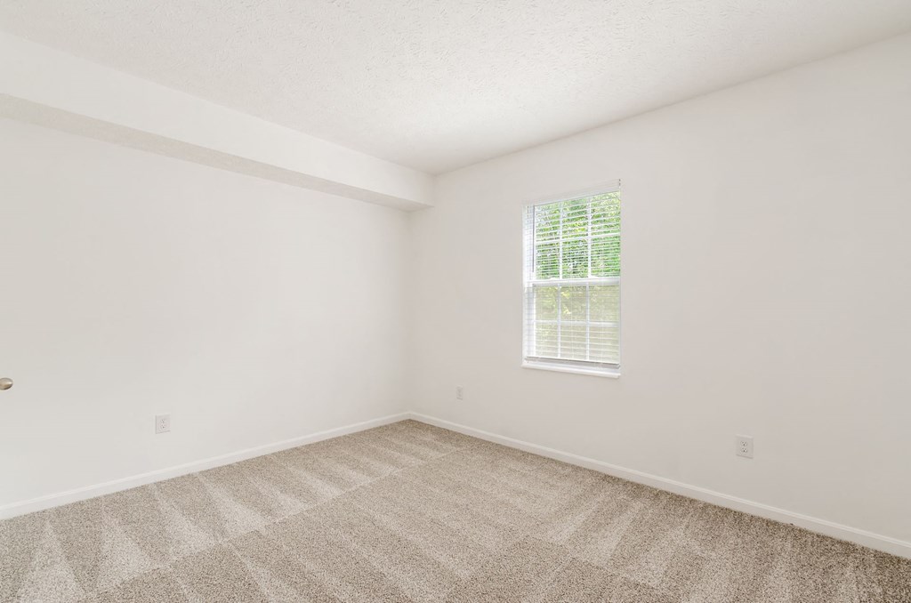 an empty room with carpet and a window at Prescott Place, Columbus, 43235