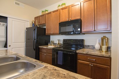 a kitchen with black appliances and granite countertops