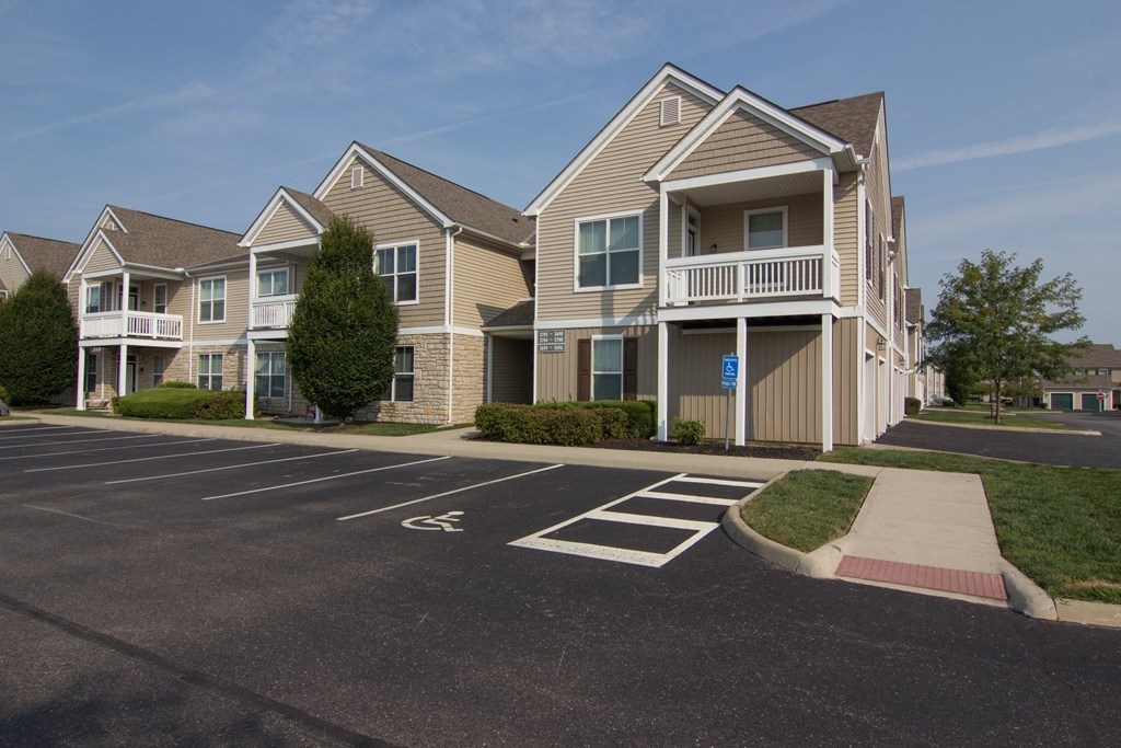 an empty parking lot in front of a row of houses  at Grove City Summit, Ohio