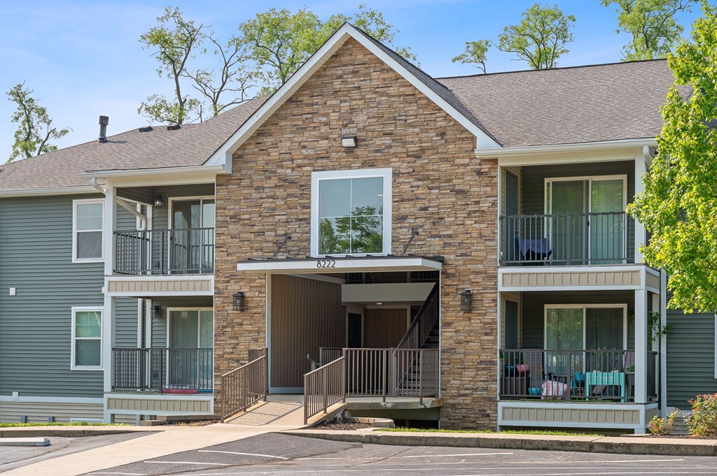 Brick house with two balconies and a porch at Galbraith Pointe Apartments and Townhomes, Cincinnati, OH