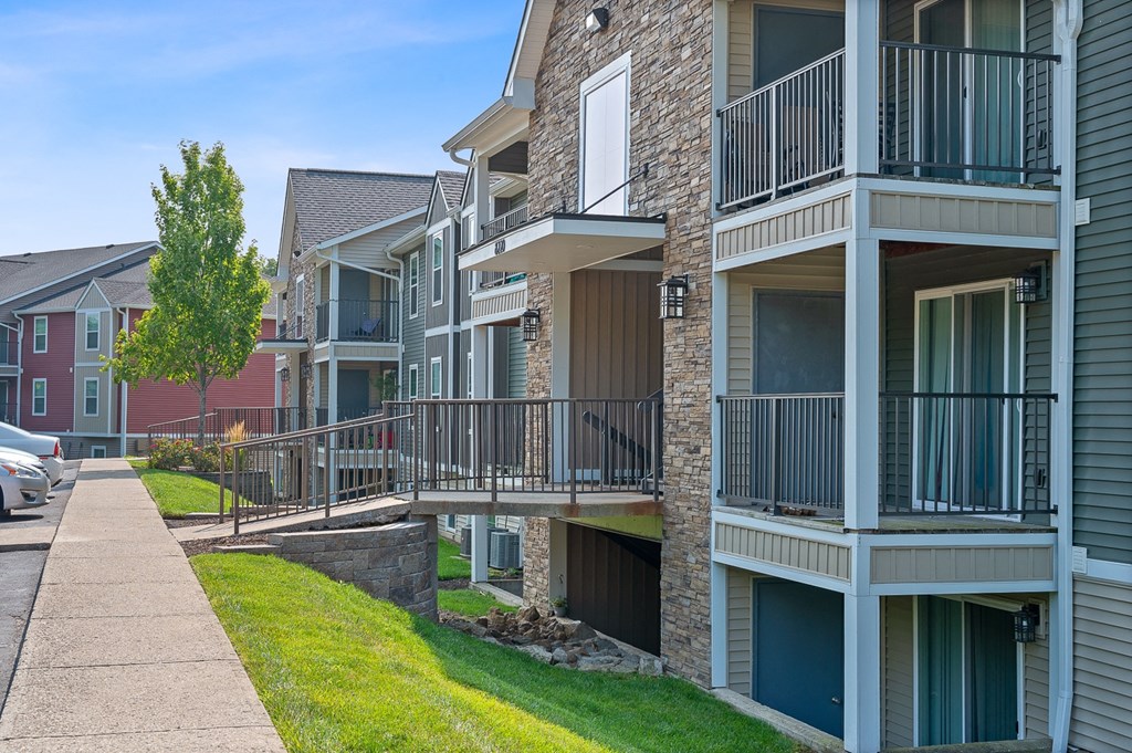 Apartment building with balconies and a sidewalk at Galbraith Pointe Apartments and Townhomes, Cincinnati, Ohio