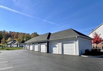 a white garage with white doors and a parking lot
