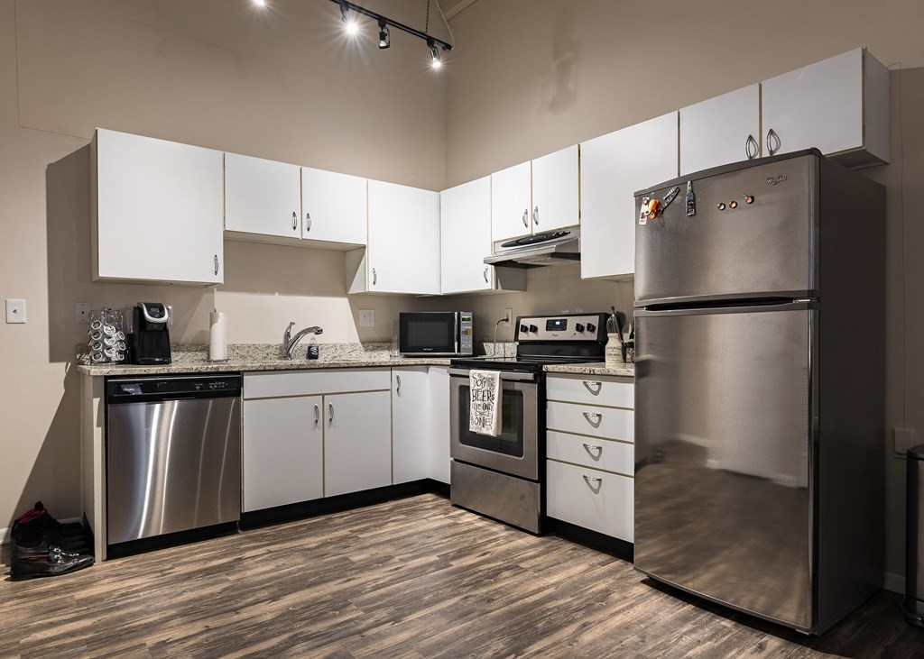 a kitchen with stainless steel appliances and white cabinets