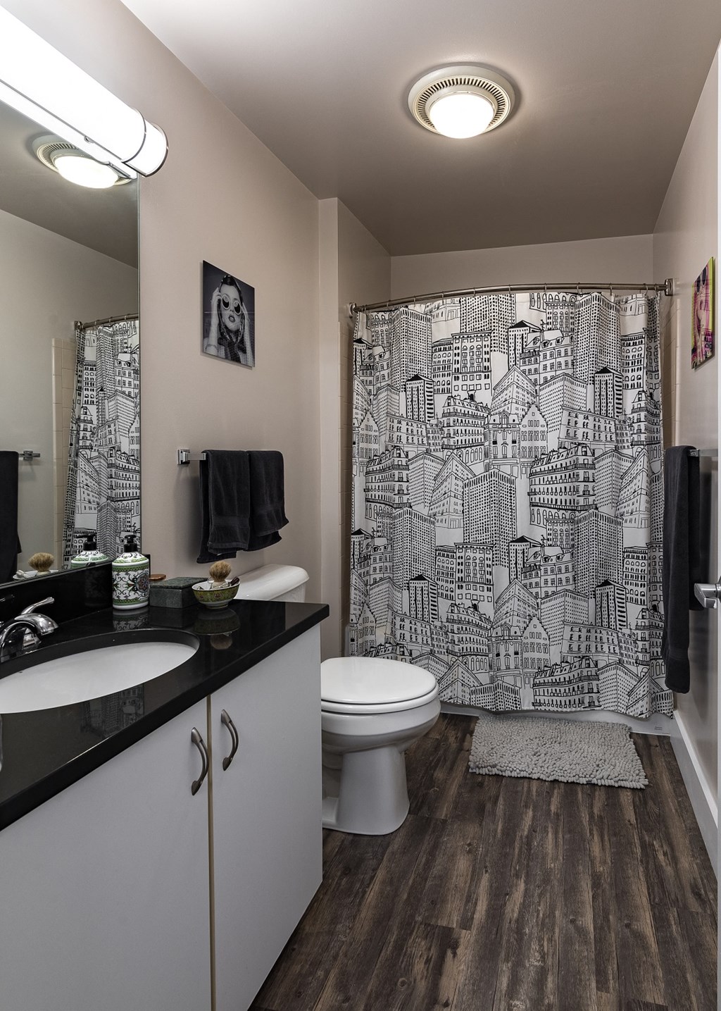 a bathroom with a shower curtain and a toilet and sink