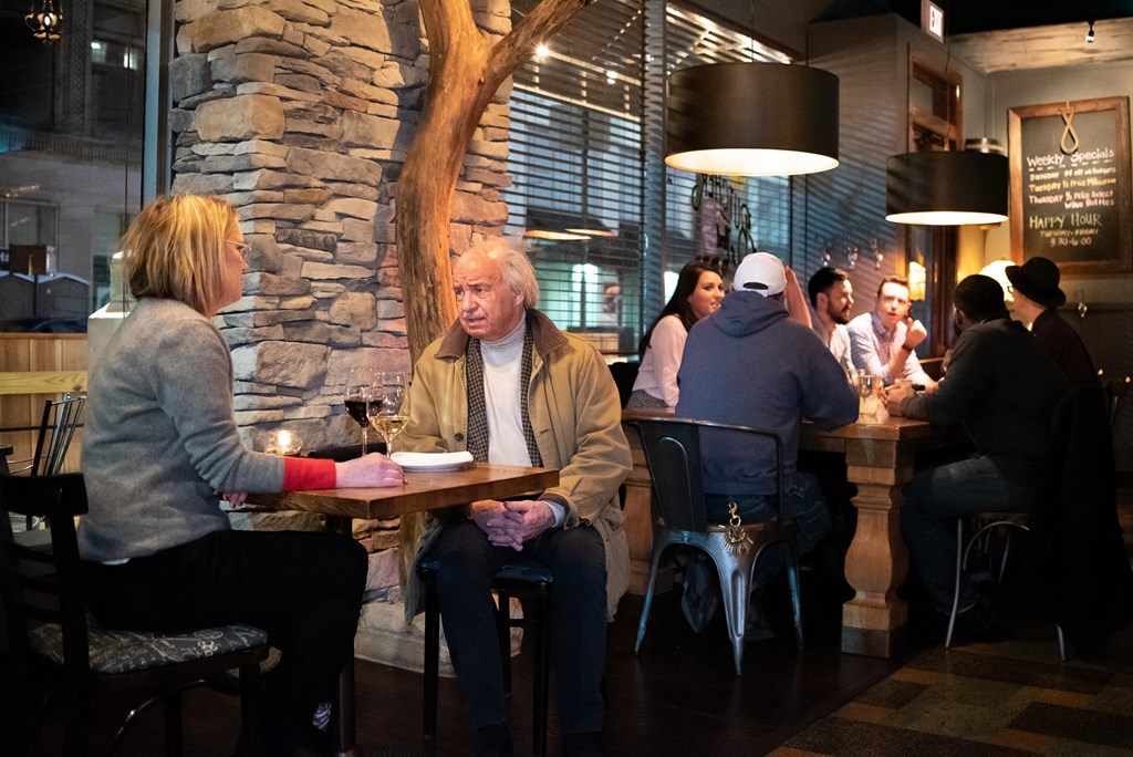 people sitting at tables in a restaurant