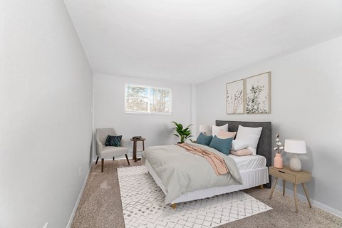 A bedroom with a large bed and a chair at The Alpine Apartments, Kettering