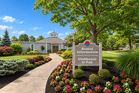 A sign in front of a building that says Rental Information Clubhouse & Pub.