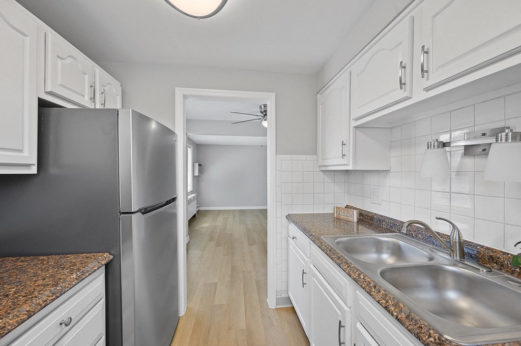 a kitchen with stainless steel appliances and white cabinets