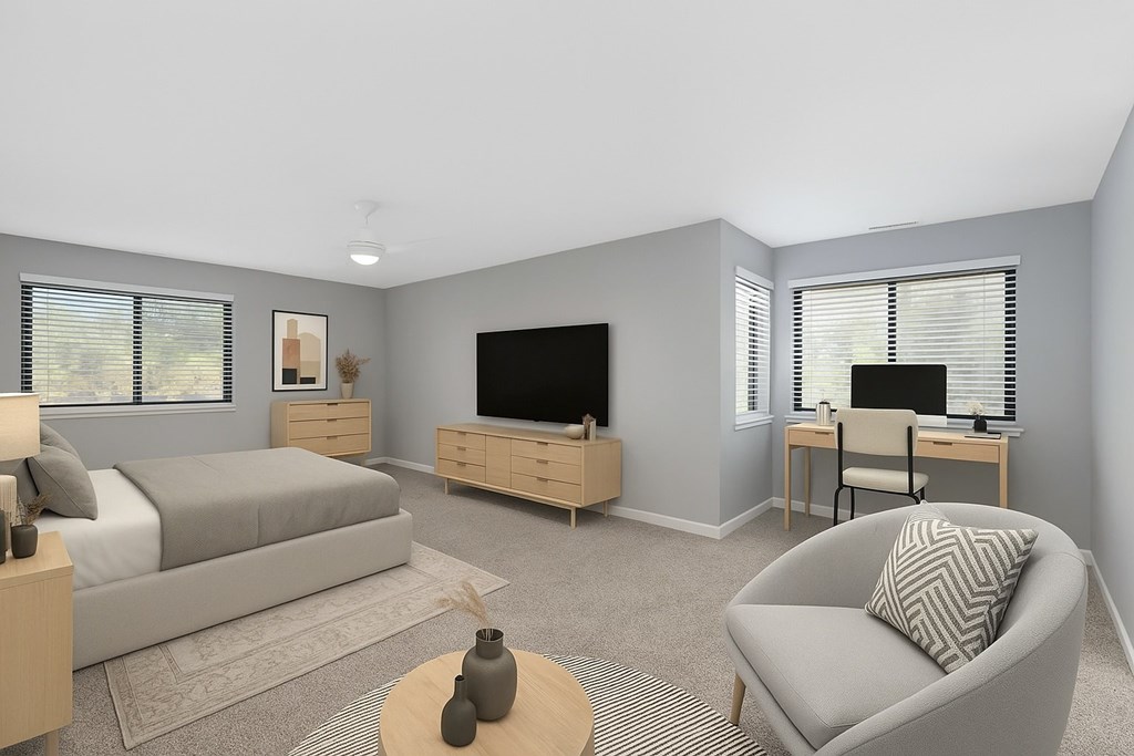 A modern living room with a grey sofa, a wooden coffee table, and a television.