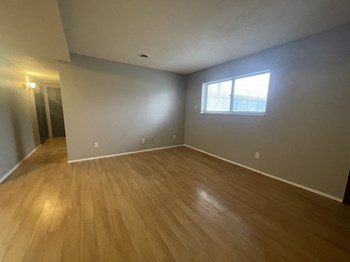 an empty room with hardwood floors and a window - Photo Gallery 13