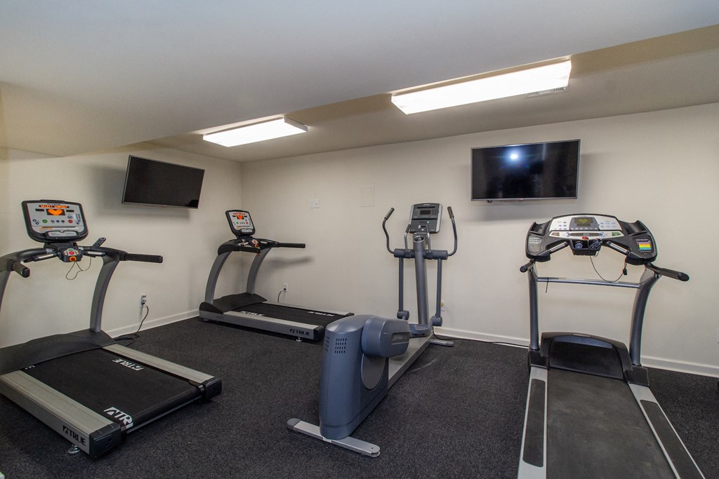 two exercise machines and a tv in a gym room at Rivers Edge Apartments and Townhomes, Dayton, OH, 45405