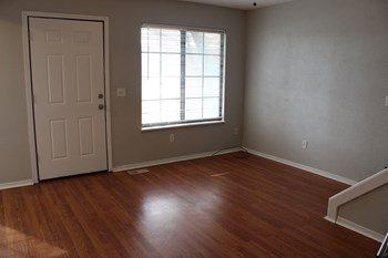a bedroom with hardwood floors and a window - Photo Gallery 28