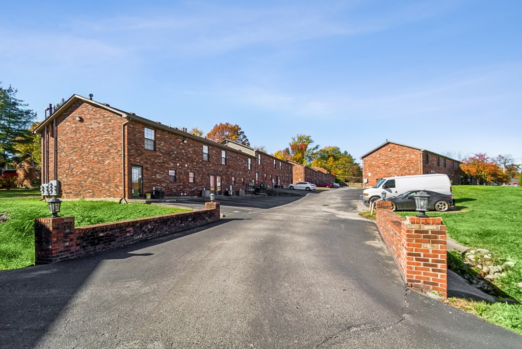 A white van is parked on the side of a road.