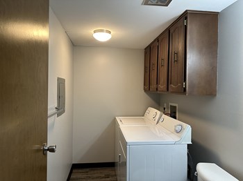 a small laundry room with a washer and dryer - Photo Gallery 22