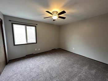 an empty room with a ceiling fan and a window - Photo Gallery 21