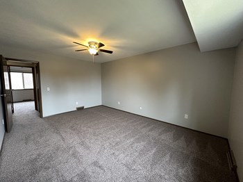 an empty room with a ceiling fan - Photo Gallery 20