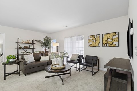 A living room with a couch, chairs, and a coffee table.