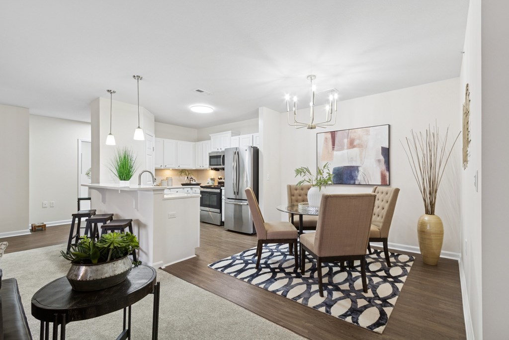 A modern kitchen with a dining table and chairs.