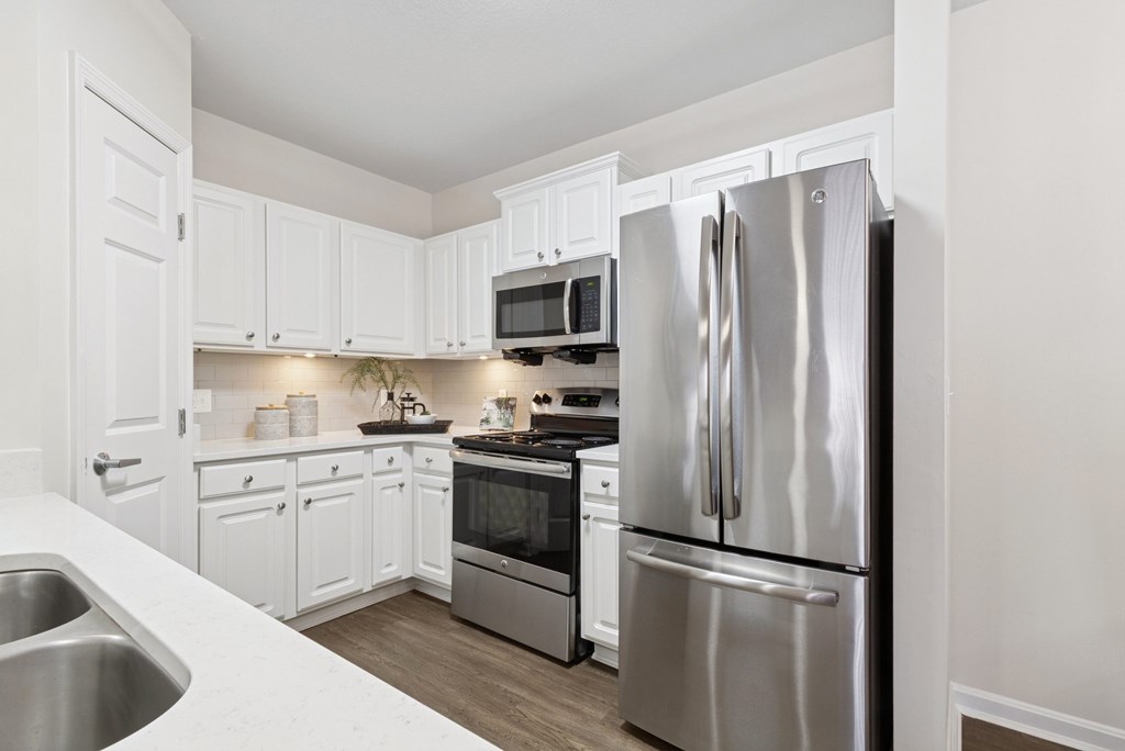 A modern kitchen with a stainless steel refrigerator.