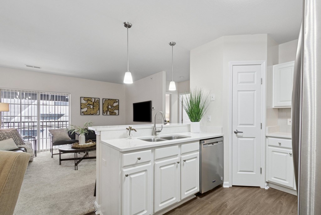 A modern kitchen with white cabinets and a large island.