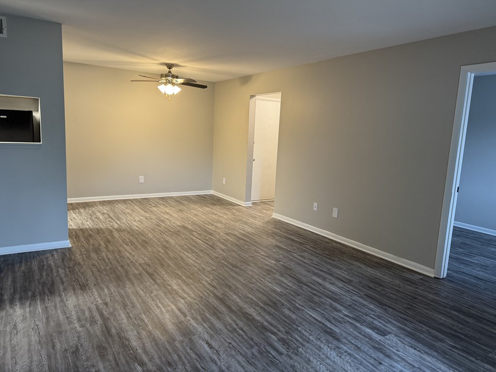 A room with a ceiling fan and a door. at Quail Run Apartments, Columbus