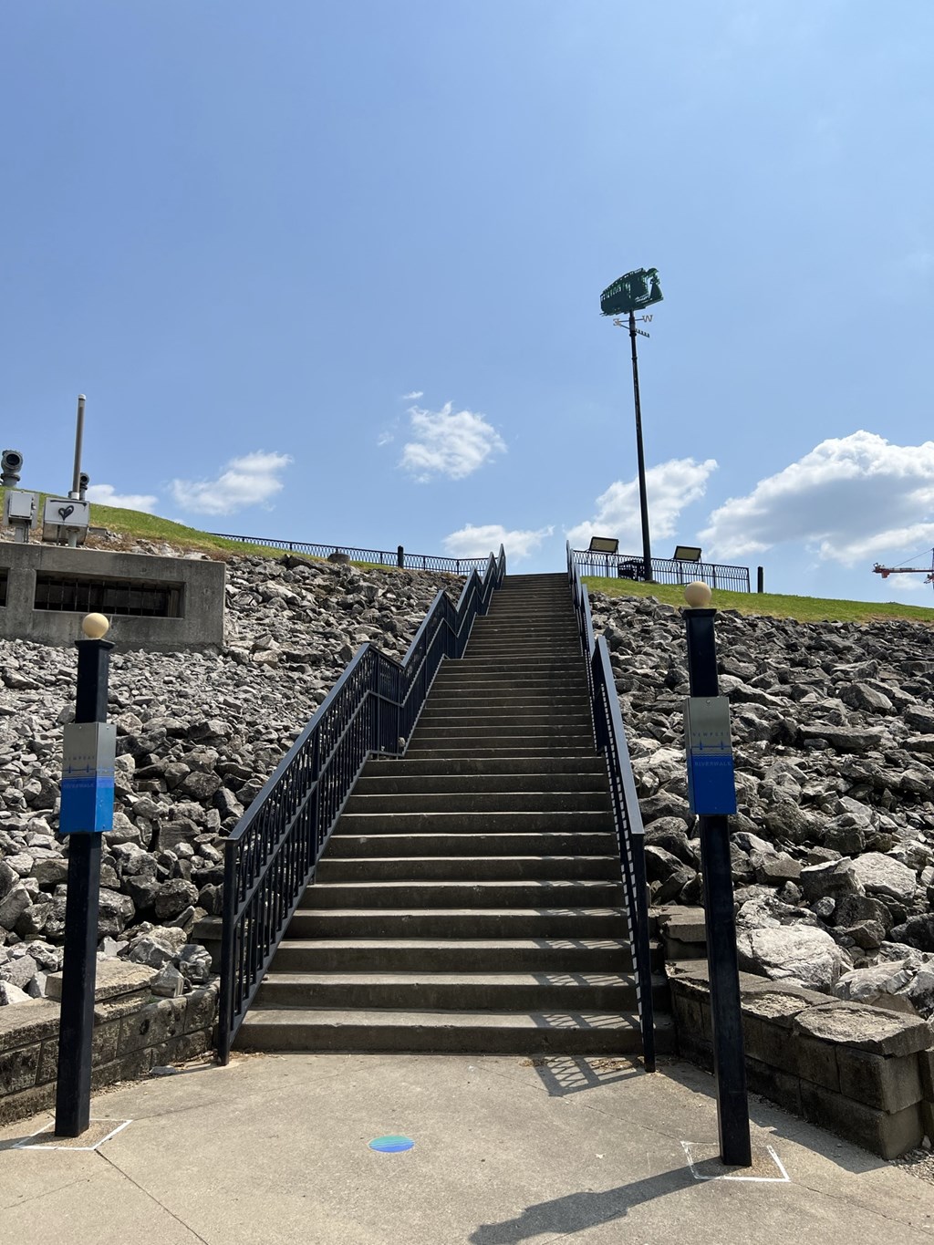 a flight of stairs leading up to the top of a hill