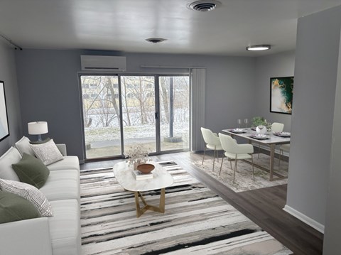A modern living room with a white sofa and a coffee table.