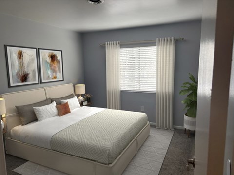 A bedroom with a large bed and two framed pictures on the wall.