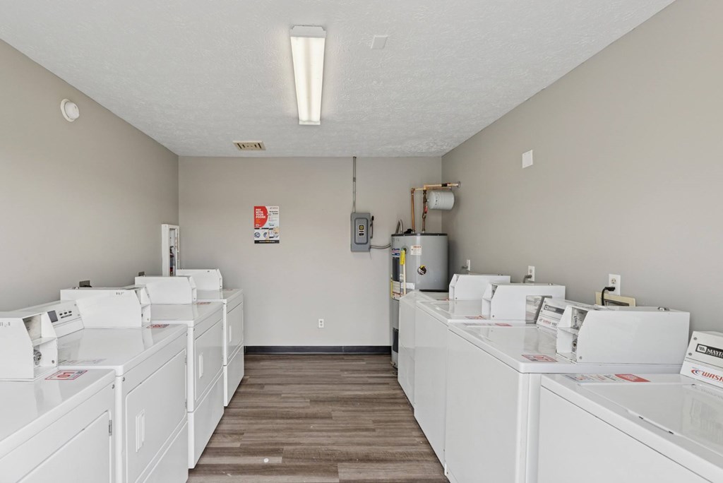 A laundromat with rows of washers and dryers.