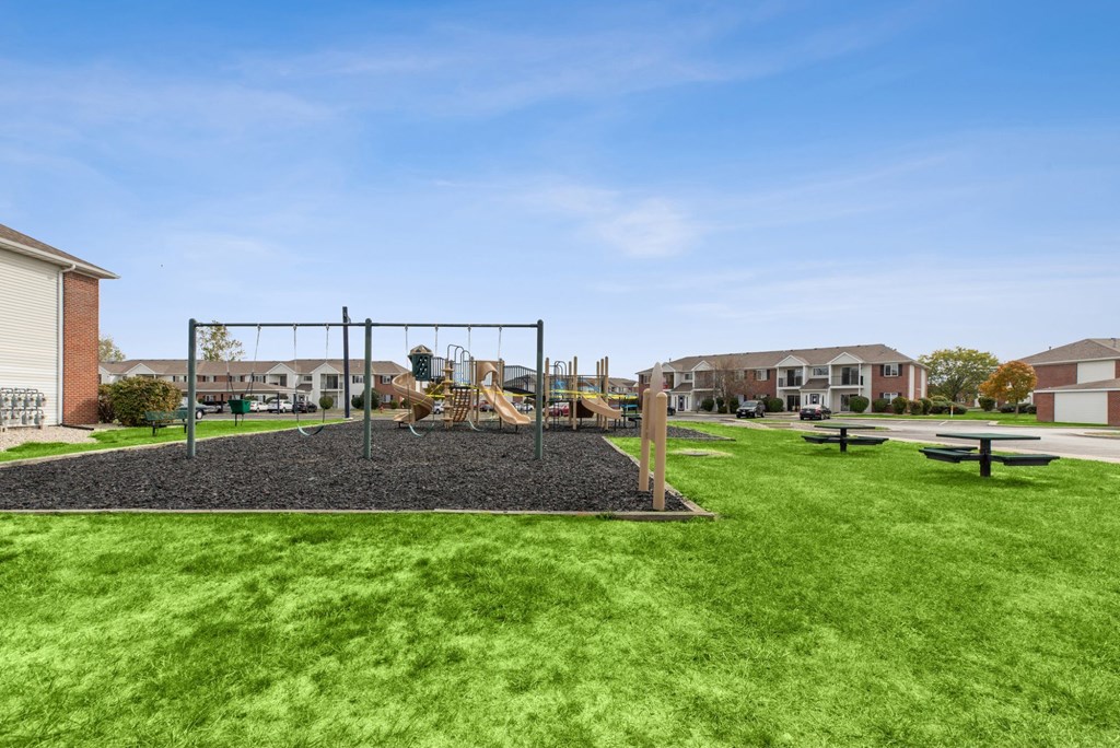 A playground with a swing set and a slide.
