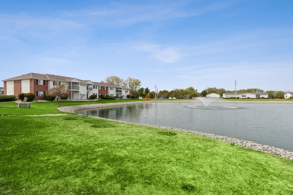 A residential area with a pond and a fountain.