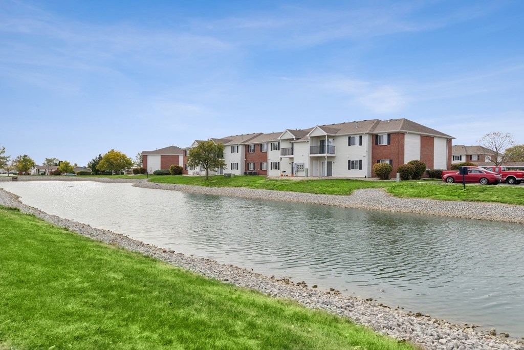 A row of houses with a body of water in front.