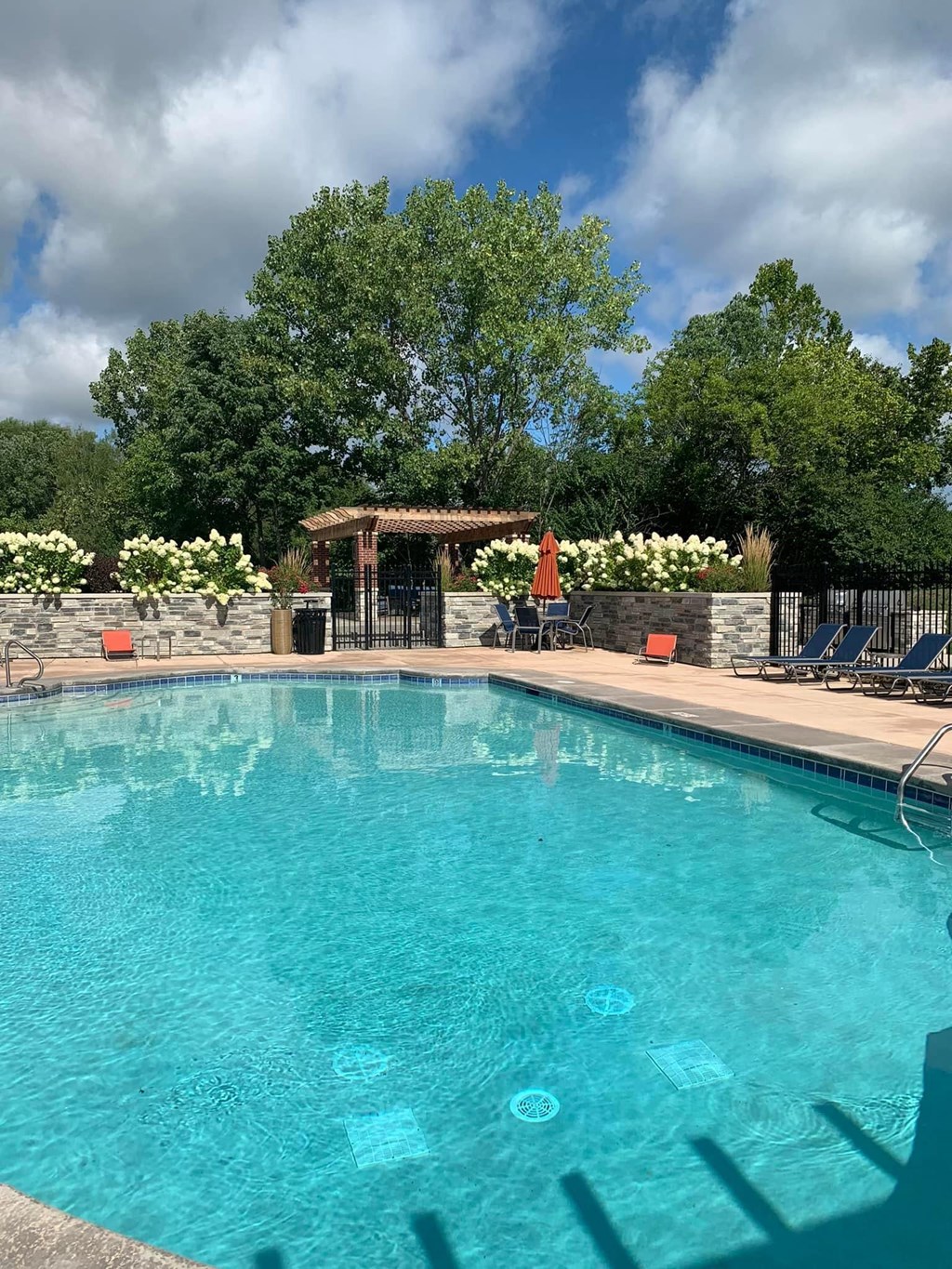 a large swimming pool with chairs around it at Ivy Hills Living Spaces, Cincinnati