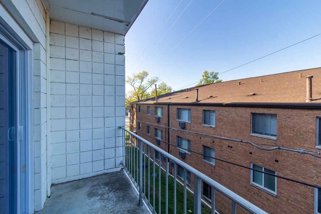 the view of a brick building from the balcony of a building