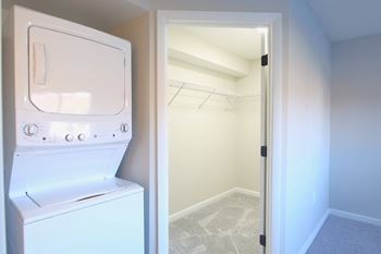 a laundry room with a washer and dryer and a closet