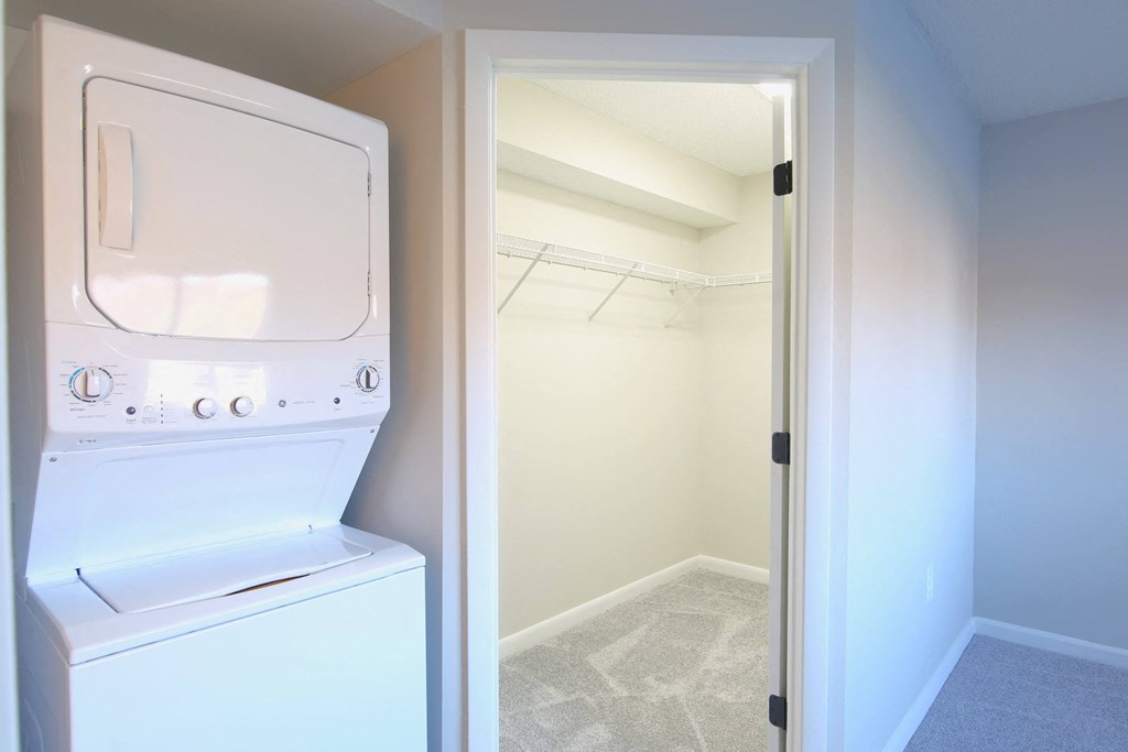 a laundry room with a washer and dryer and a closet