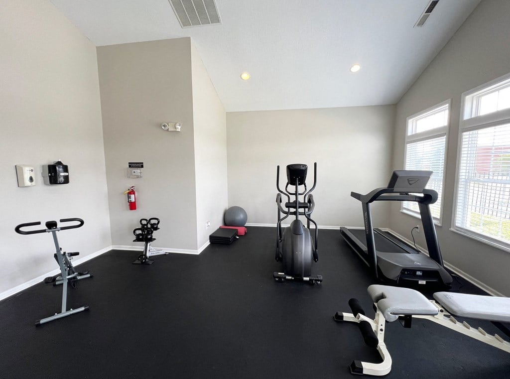 a gym with treadmills and other exercise equipment in a building at Traditions at Slate Ridge, Reynoldsburg