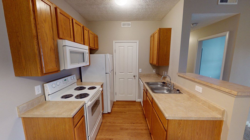 a kitchen with wooden cabinets and white appliances and a sink at Prescott Place, Columbus, OH, 43235