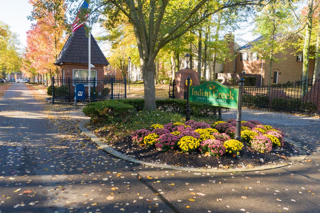 Park with a sign and flowers in front of a building at Indian Creek Apartments, Cincinnati, Ohio