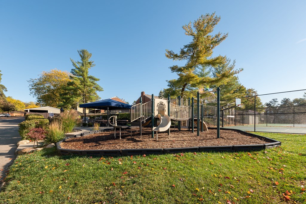 Playground with a slide and a swing set in a park at Indian Creek Apartments, Cincinnati, OH